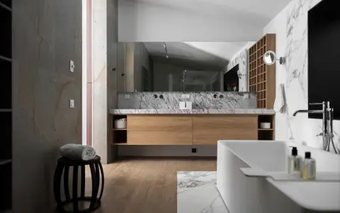 Salle de bain moderne avec meuble en bois clair, marbre et baignoire. Le bois est un excellent choix pour le meuble de salle de bain, alliant esthétique et durabilité.