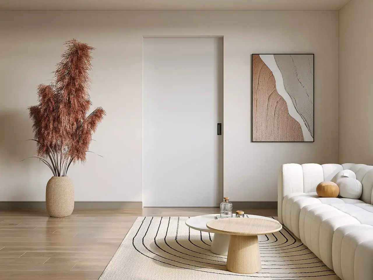 Salon moderne avec une plante décorative, un tableau abstrait et un canapé blanc. Une porte coulissante blanche, discrète, s'intègre au mur.